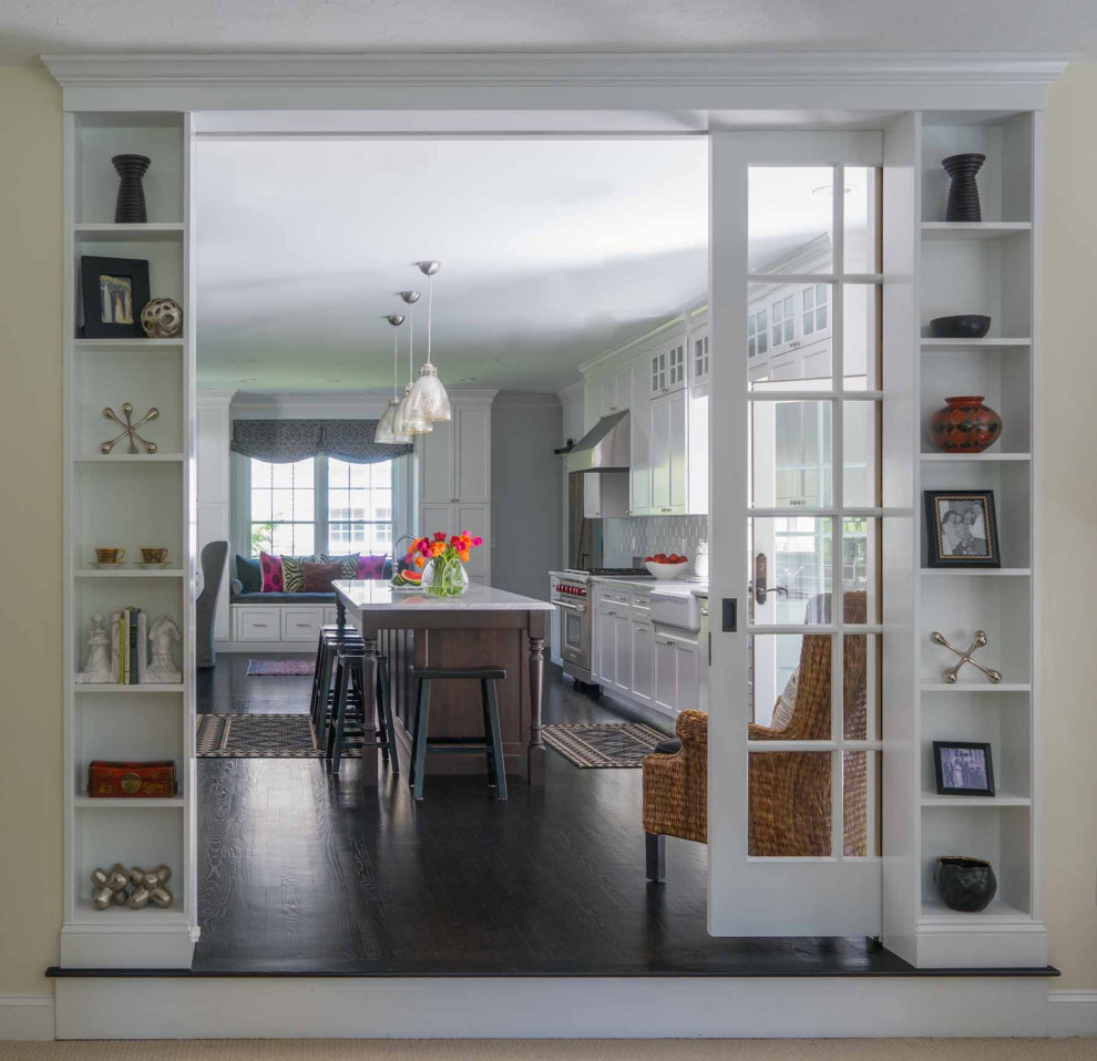 Mid-sized transitional galley dark wood floor and brown floor eat-in kitchen photo in Boston with white cabinets, marble countertops, white backsplash, subway tile backsplash, stainless steel appliances, an island and gray countertops