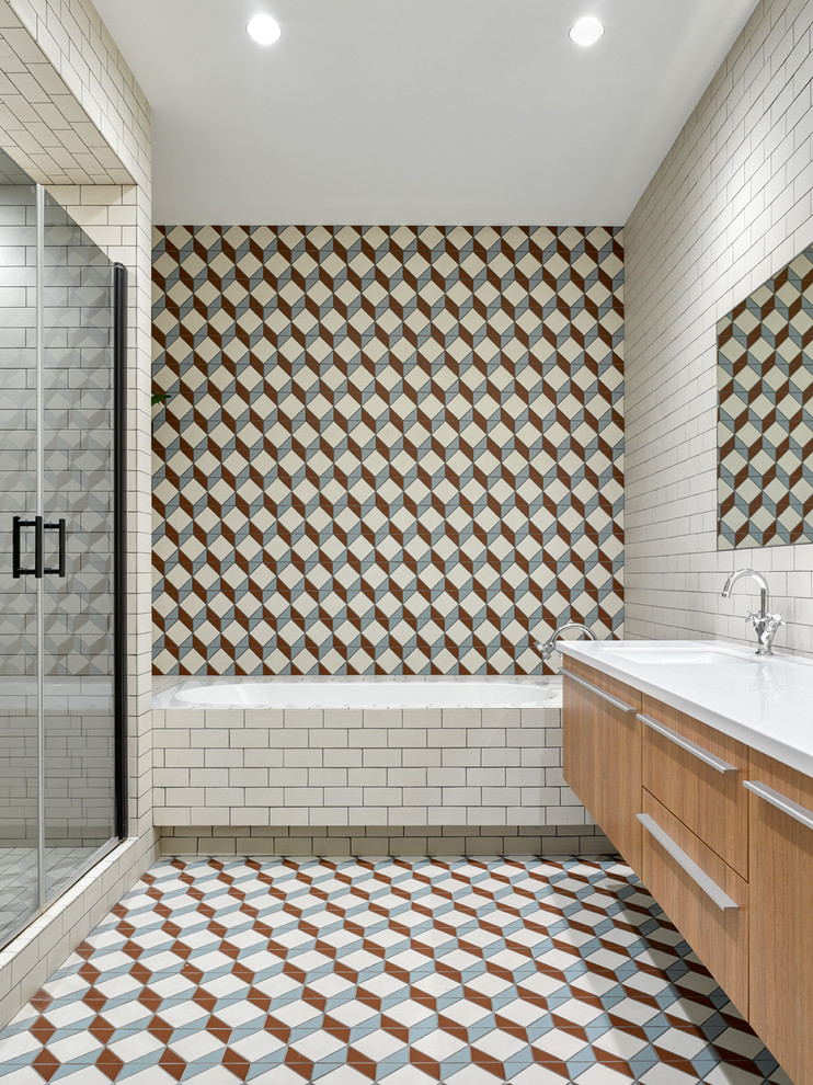 Design ideas for a mid-sized contemporary master bathroom in Moscow with an alcove shower, multi-coloured tile, cement tile, cement tiles, an undermount sink, engineered quartz benchtops, multi-coloured floor, a hinged shower door, flat-panel cabinets, medium wood cabinets and a drop-in tub.