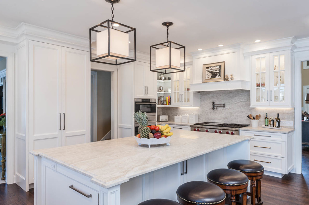 Large transitional u-shaped eat-in kitchen in Indianapolis with an undermount sink, beaded inset cabinets, white cabinets, marble benchtops, multi-coloured splashback, stone slab splashback, stainless steel appliances, medium hardwood floors and with island.