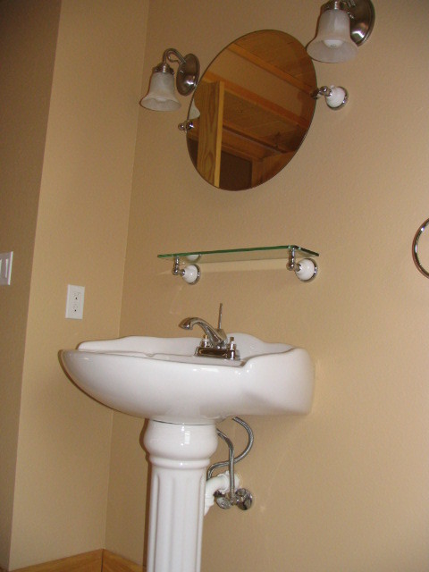 Claw-foot bathtub - large rustic brown tile and ceramic tile ceramic tile claw-foot bathtub idea with a two-piece toilet, brown walls and a pedestal sink
