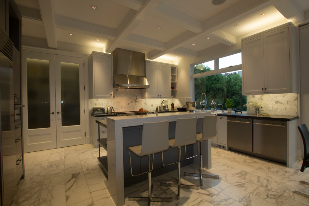 Enclosed kitchen - large transitional l-shaped marble floor, white floor and coffered ceiling enclosed kitchen idea in Toronto with a farmhouse sink, shaker cabinets, white cabinets, quartzite countertops, white backsplash, marble backsplash, stainless steel appliances, an island and gray countertops