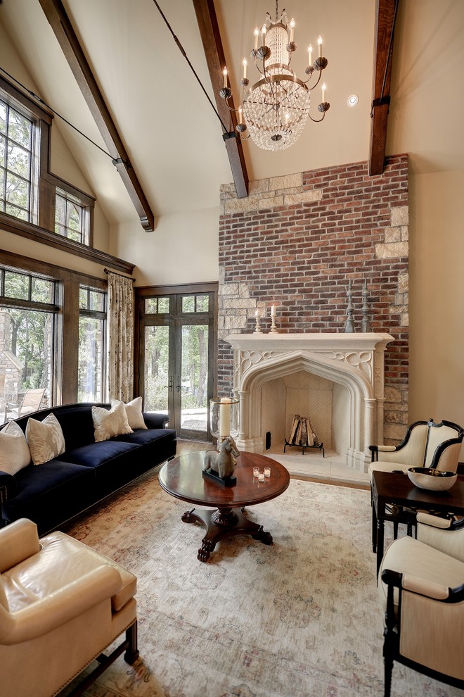 This is an example of a traditional formal open concept living room in Minneapolis with beige walls, a standard fireplace, a stone fireplace surround and no tv.