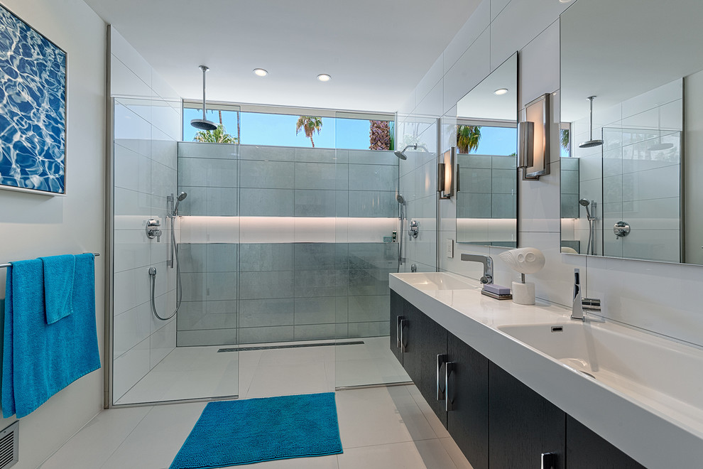 This is an example of a midcentury bathroom in Los Angeles with an integrated sink, flat-panel cabinets, dark wood cabinets, a double shower and white tile.