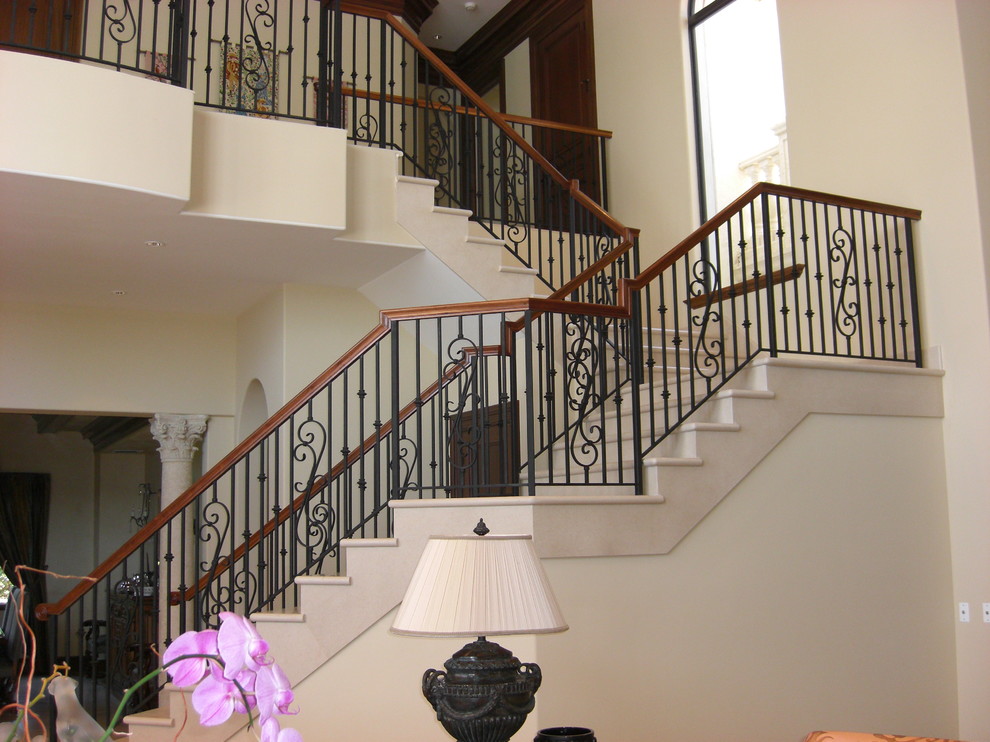Photo of a large mediterranean l-shaped staircase in Miami.