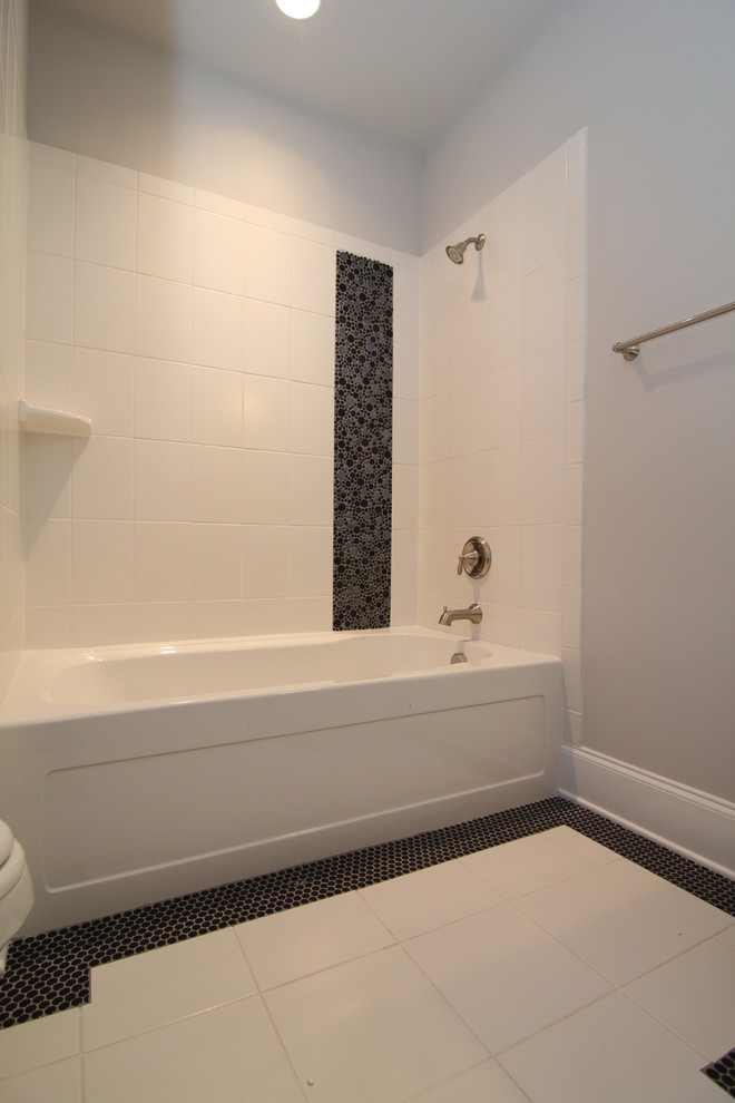 Inspiration for a large contemporary kids bathroom in Raleigh with recessed-panel cabinets, dark wood cabinets, a corner tub, a corner shower, a one-piece toilet, white tile, mosaic tile, grey walls, ceramic floors, an integrated sink and solid surface benchtops.