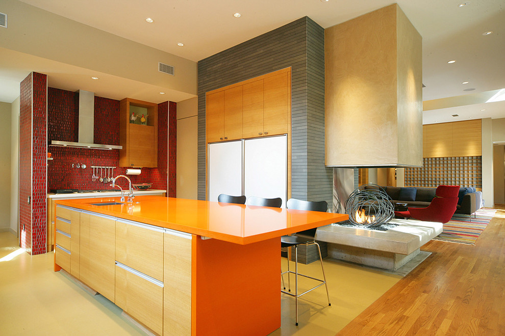 This is an example of a contemporary kitchen in Dallas with red splashback and orange benchtop.