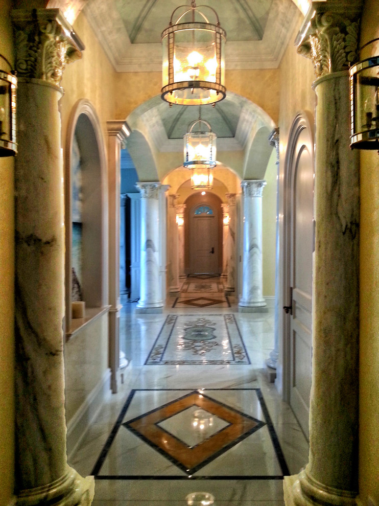 Design ideas for a mid-sized traditional entry hall in Miami with yellow walls, marble floors, a single front door and a white front door.