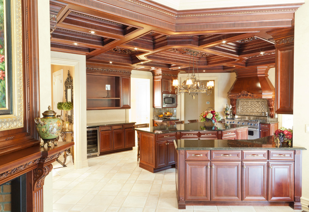 This is an example of a large traditional u-shaped eat-in kitchen in New York with an undermount sink, raised-panel cabinets, brown cabinets, granite benchtops, stainless steel appliances, ceramic floors and with island.