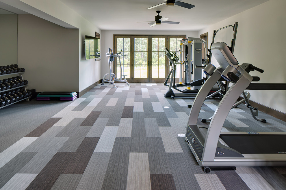 Photo of a large eclectic multipurpose gym with beige walls, carpet and multi-coloured floor.