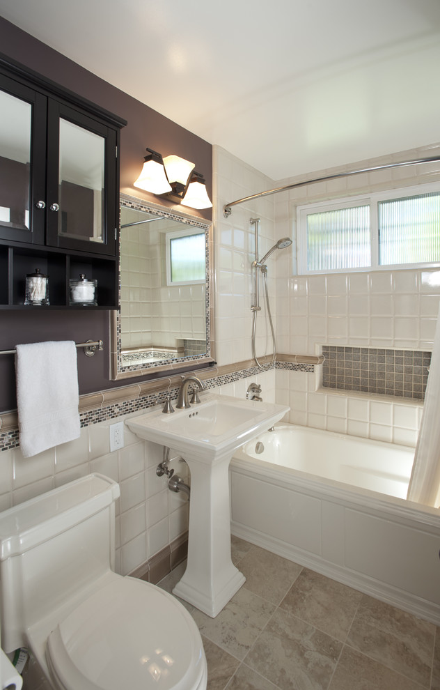 Mid-sized traditional 3/4 bathroom in San Francisco with a pedestal sink, shaker cabinets, black cabinets, an alcove tub, a shower/bathtub combo, a one-piece toilet, ceramic tile, white tile, purple walls, travertine floors, beige floor, a shower curtain, a niche and a single vanity.