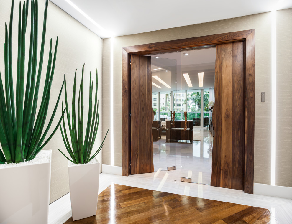Inspiration for a large contemporary entryway in Miami with white walls and linoleum floors.
