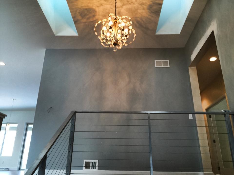 Example of a large painted wood floor hallway design with gray walls