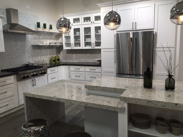 Inspiration for a mid-sized transitional l-shaped dark wood floor and gray floor enclosed kitchen remodel in Orange County with white cabinets, gray backsplash, mosaic tile backsplash, stainless steel appliances, shaker cabinets, granite countertops and an island