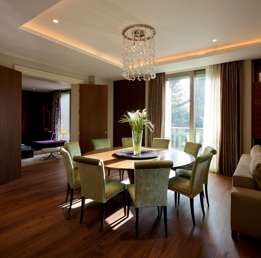 Design ideas for a contemporary dining room in London with beige walls and dark hardwood floors.