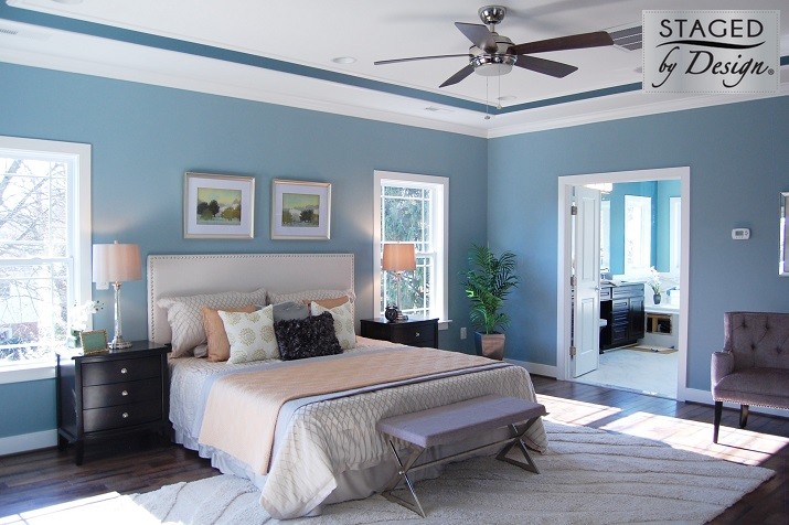 This is an example of a large transitional master bedroom in DC Metro with blue walls and dark hardwood floors.