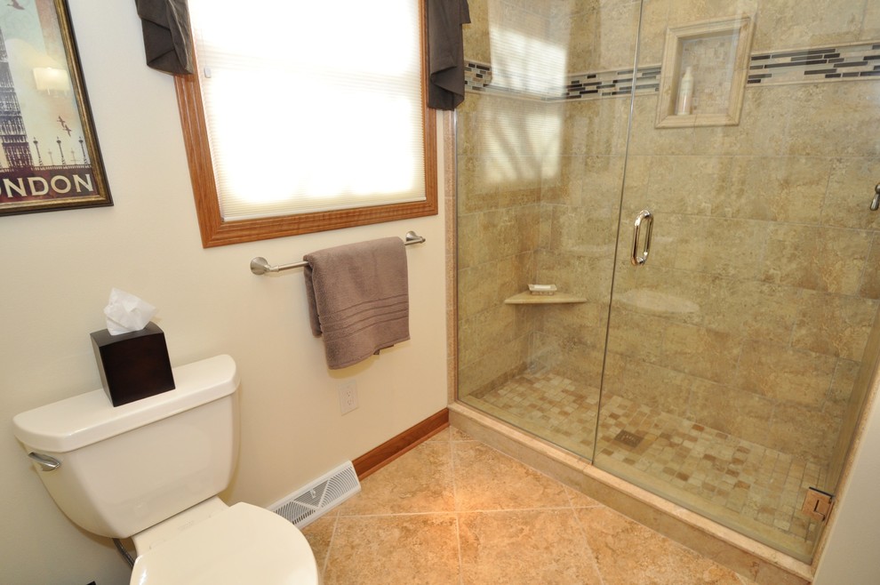 Photo of a mid-sized transitional master bathroom in Milwaukee with an undermount sink, granite benchtops, an undermount tub, an alcove shower, a two-piece toilet, beige tile, ceramic tile, white walls, porcelain floors, shaker cabinets and dark wood cabinets.