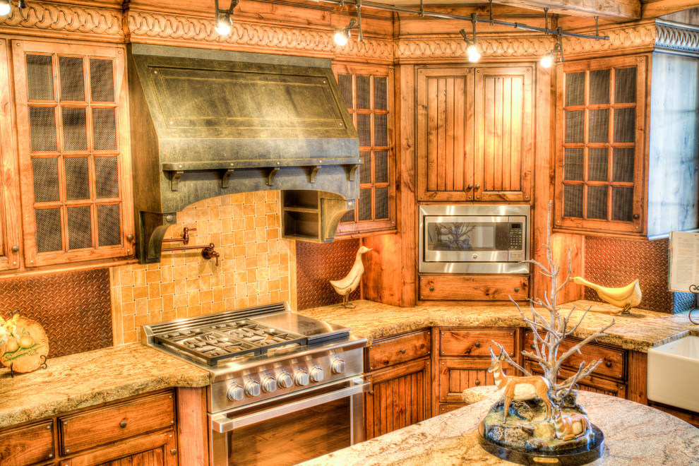 Inspiration for a mid-sized rustic l-shaped dark wood floor open concept kitchen remodel with a farmhouse sink, recessed-panel cabinets, distressed cabinets, granite countertops, metallic backsplash, metal backsplash, an island and stainless steel appliances