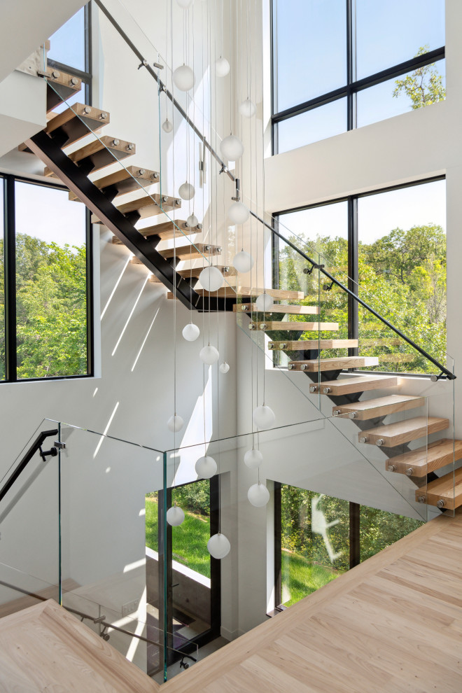 Imagen de escalera suspendida con barandilla de vidrio