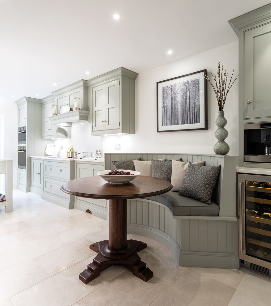 This is an example of a small traditional kitchen in Manchester with shaker cabinets, grey cabinets and marble floors.