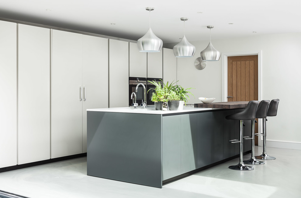 Inspiration for a contemporary single-wall open plan kitchen in London with flat-panel cabinets, white cabinets and a peninsula.
