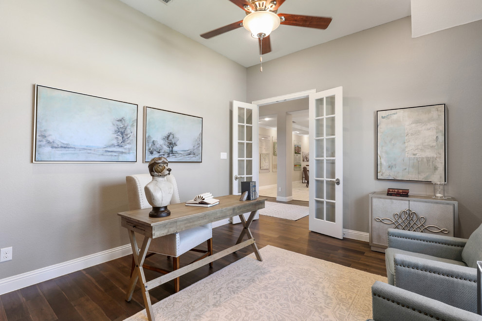 This is an example of a mid-sized traditional study room in Dallas with beige walls, light hardwood floors, a freestanding desk and brown floor.