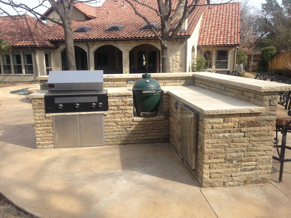 Example of a large mountain style backyard stamped concrete and custom-shaped natural hot tub design in Dallas