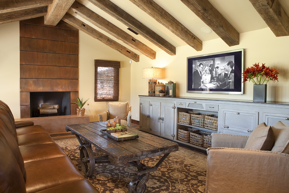 Inspiration for a mid-sized traditional enclosed family room in Phoenix with a metal fireplace surround, a standard fireplace, beige walls, dark hardwood floors, a wall-mounted tv and brown floor.