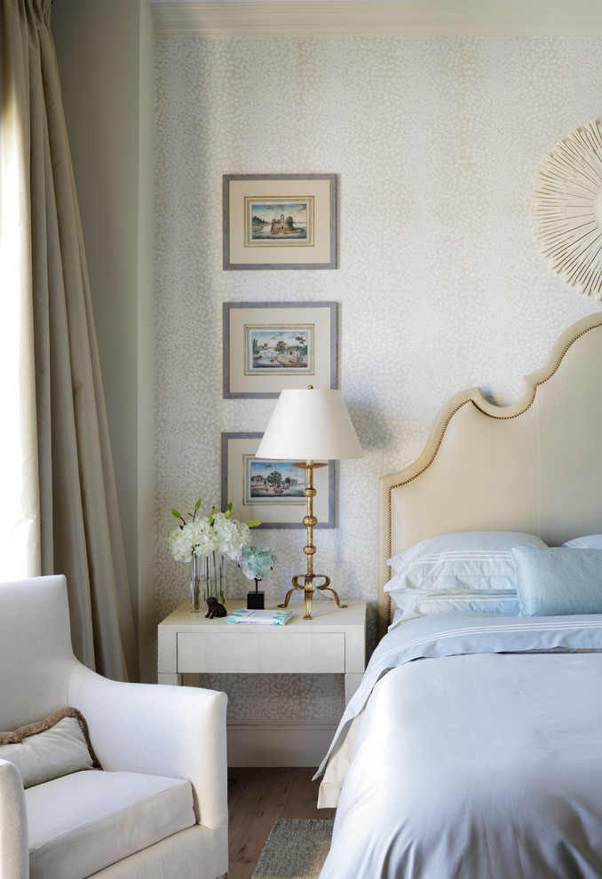 Inspiration for a transitional guest bedroom in Miami with beige walls and light hardwood floors.