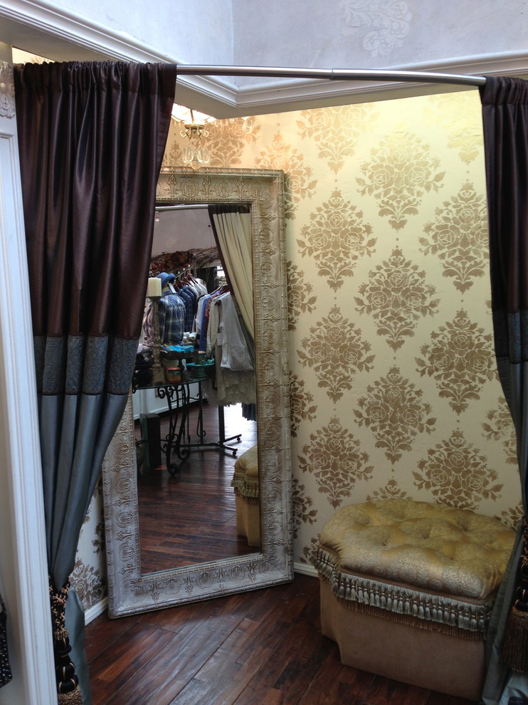 This is an example of a mid-sized eclectic women's dressing room in San Diego with medium hardwood floors.