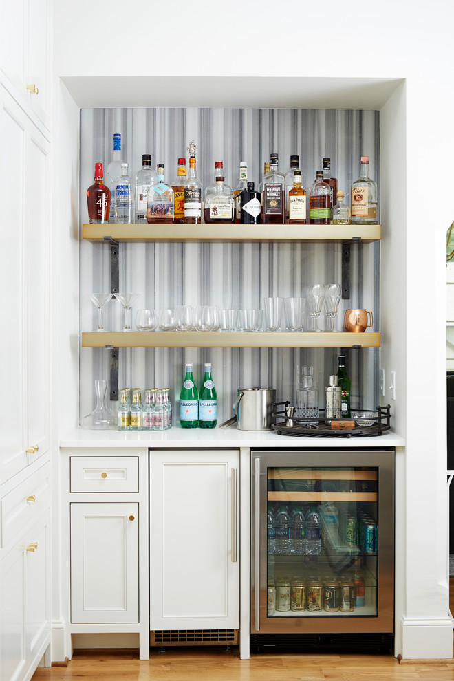 Photo of a transitional single-wall home bar in Birmingham with no sink, multi-coloured splashback and recessed-panel cabinets.