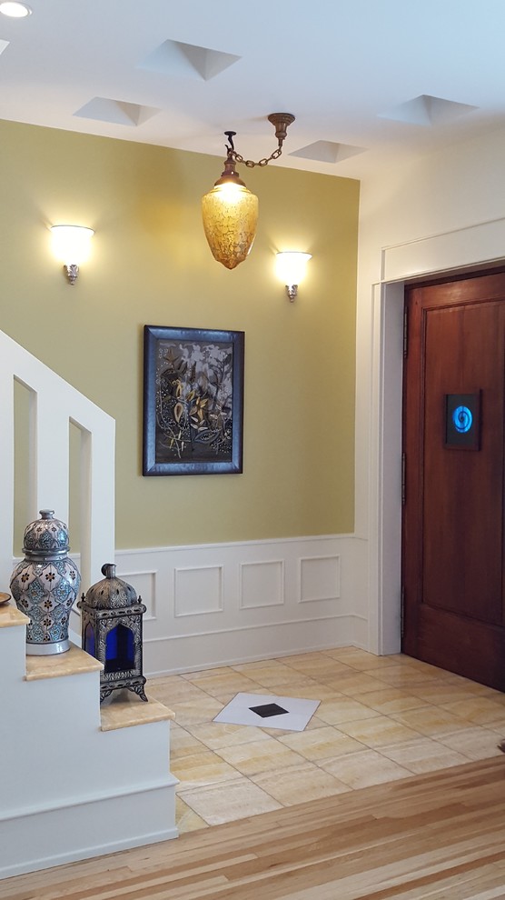 Mid-sized mediterranean foyer in Chicago with multi-coloured walls, marble floors, a single front door, yellow floor and a light wood front door.