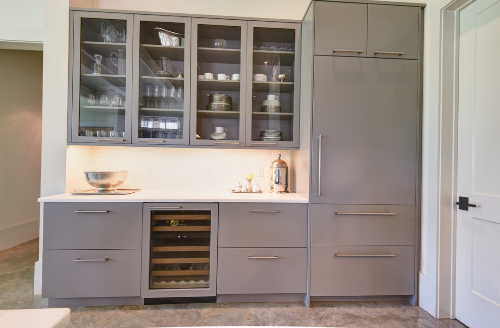 Inspiration for a mid-sized transitional l-shaped open concept kitchen remodel in New Orleans with a farmhouse sink, flat-panel cabinets, gray cabinets, paneled appliances and an island