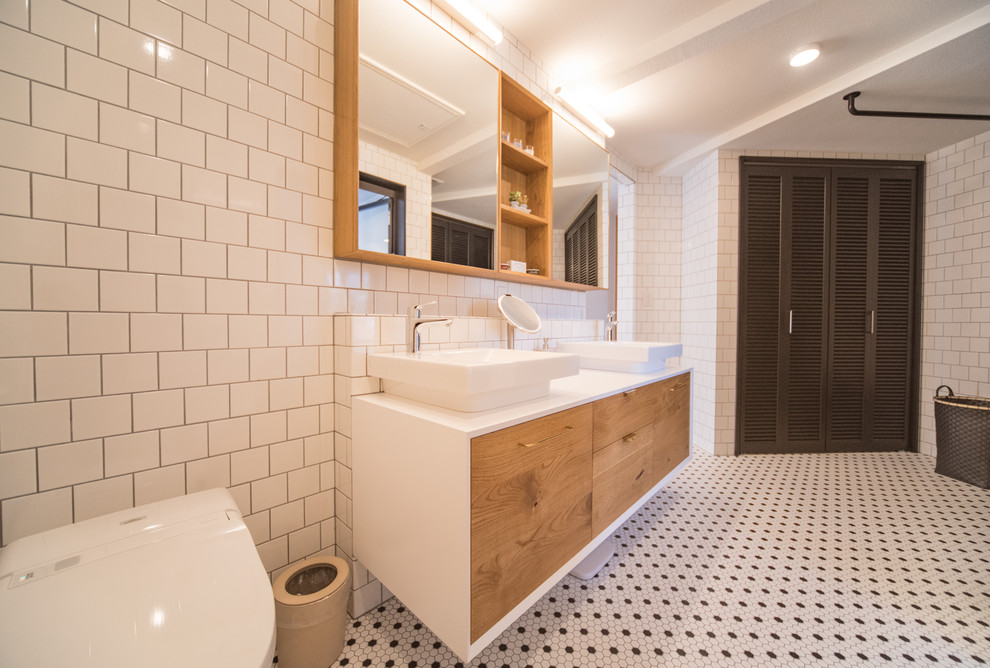 Design ideas for a midcentury powder room in Other with flat-panel cabinets, medium wood cabinets, white tile, white walls, ceramic floors, a vessel sink and multi-coloured floor.