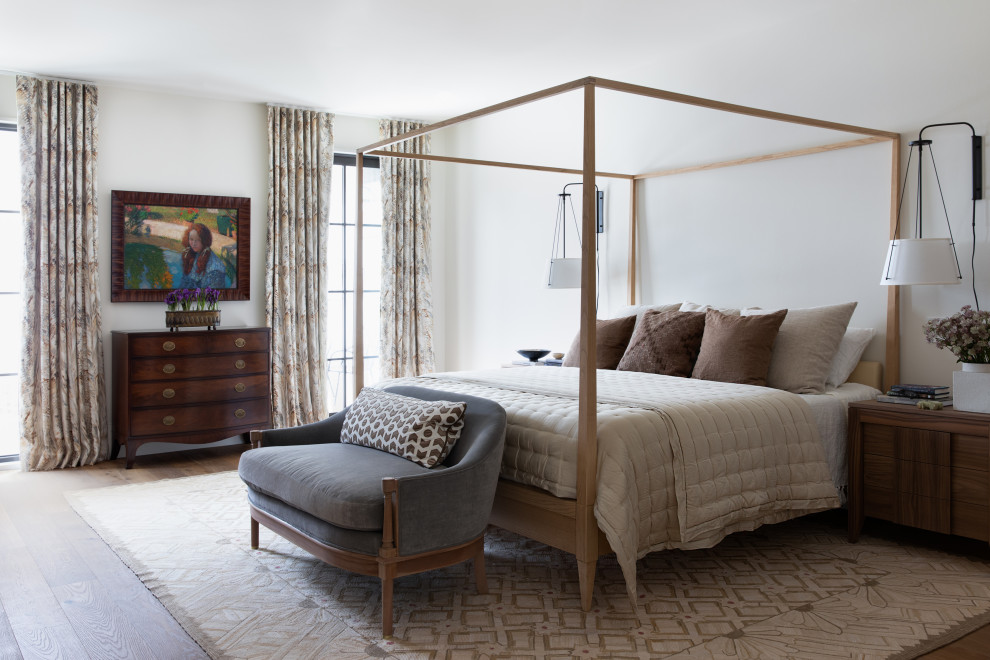 Photo of a transitional bedroom in Dallas with white walls, dark hardwood floors and brown floor.