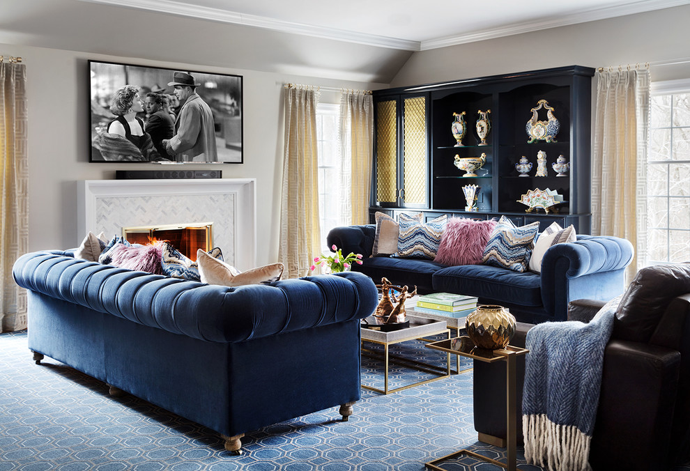 This is an example of a transitional family room in New York with grey walls, carpet, a standard fireplace, a tile fireplace surround, a wall-mounted tv and blue floor.