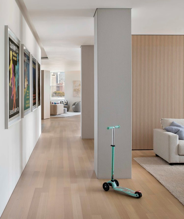Design ideas for a mid-sized modern hallway in Denver with white walls, light hardwood floors and beige floor.