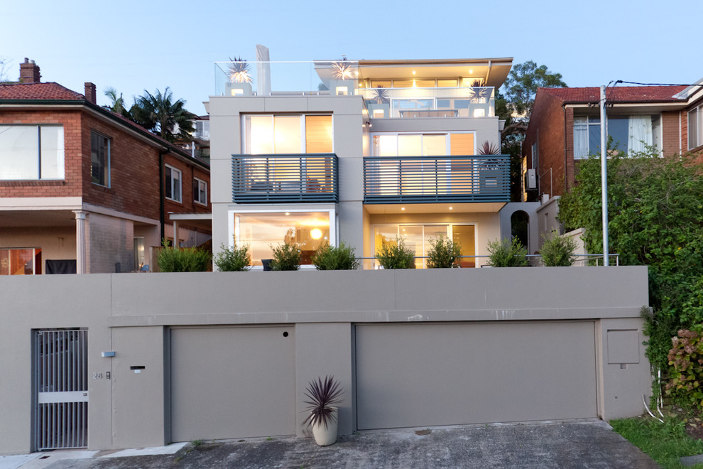 Inspiration for a mid-sized contemporary three-storey grey house exterior in Sydney with concrete fiberboard siding, a flat roof and a metal roof.