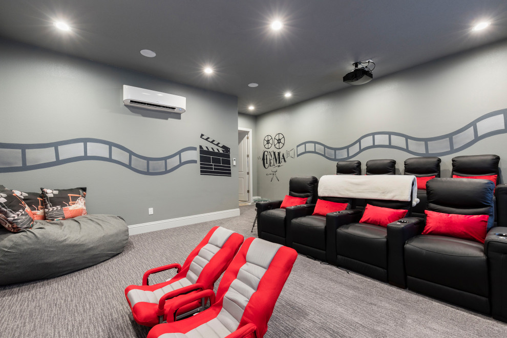 Photo of a mid-sized contemporary enclosed home theatre in Orlando with grey walls, carpet, a projector screen and grey floor.