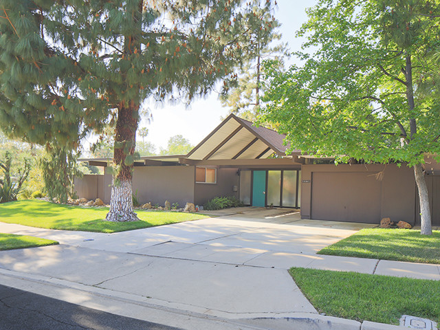 This is an example of a large midcentury one-storey brown exterior in Orange County.