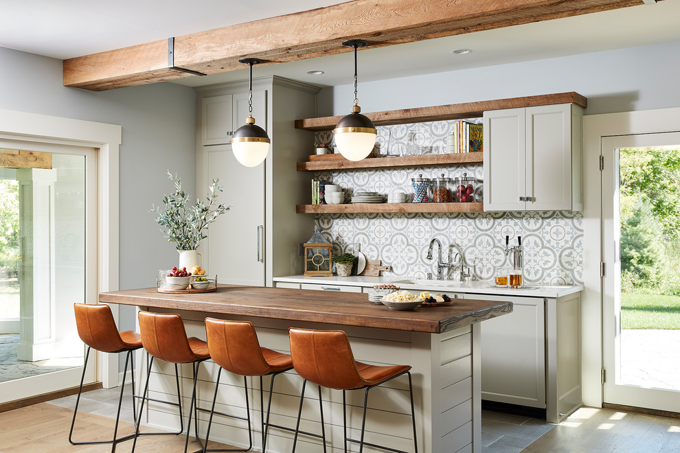 Beach style gray floor kitchen photo in Minneapolis with an undermount sink, shaker cabinets, gray cabinets, multicolored backsplash, paneled appliances, an island and white countertops