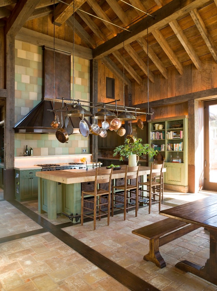 Country kitchen in San Francisco with wood benchtops, green cabinets and beige benchtop.
