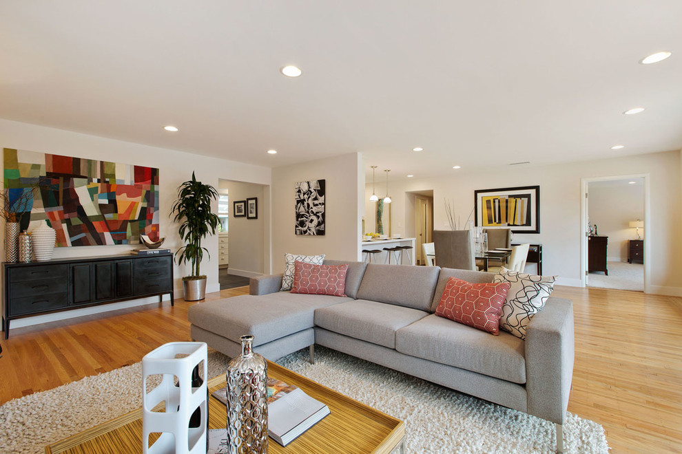 Mid-sized modern open concept living room in San Francisco with white walls, medium hardwood floors and no tv.
