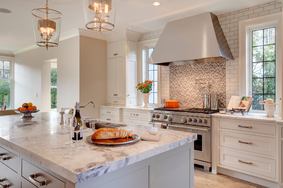 Inspiration for a large transitional u-shaped eat-in kitchen in Phoenix with an undermount sink, white cabinets, granite benchtops, grey splashback, subway tile splashback, stainless steel appliances, porcelain floors, with island, shaker cabinets and beige floor.
