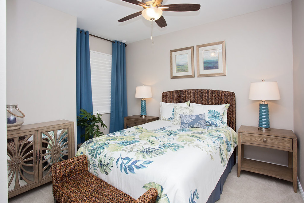Photo of a mid-sized beach style guest bedroom in Miami with beige walls, carpet, no fireplace and beige floor.