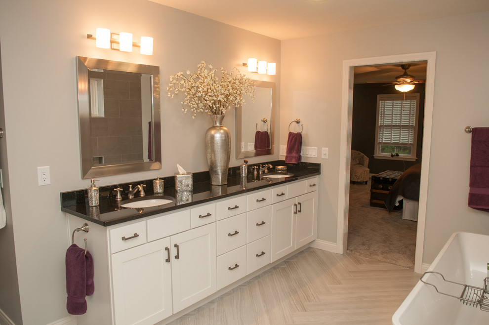 Inspiration for a large transitional master gray tile and porcelain tile light wood floor and beige floor freestanding bathtub remodel with white cabinets, gray walls, shaker cabinets, an undermount sink and quartzite countertops