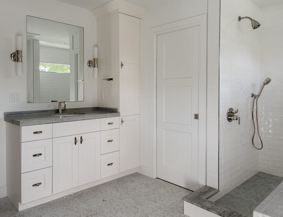 Photo of a medium sized coastal ensuite bathroom in Miami with shaker cabinets, white cabinets, a double shower, white tiles, porcelain tiles, white walls, porcelain flooring, a submerged sink, marble worktops, blue floors, an open shower, blue worktops, a single sink and a built in vanity unit.