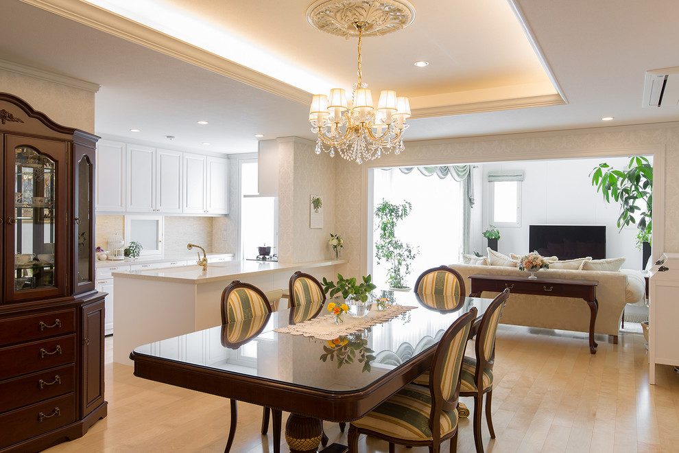 This is an example of a traditional open plan dining with beige floor, beige walls and painted wood floors.