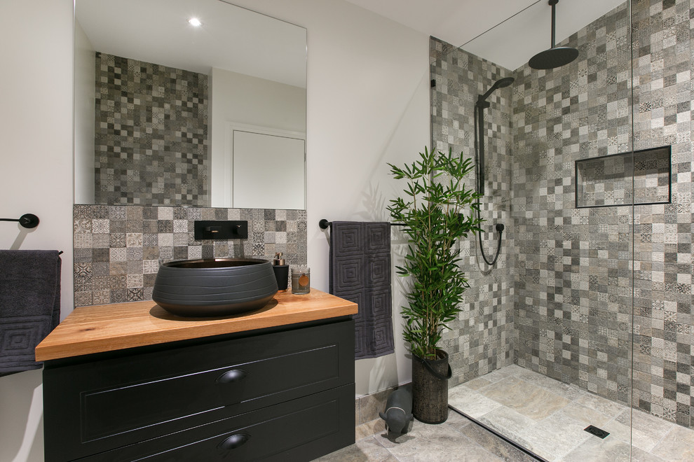 Photo of a small traditional bathroom in Cairns with shaker cabinets, black cabinets, a double shower, a wall-mount toilet, travertine floors, tile benchtops and an open shower.