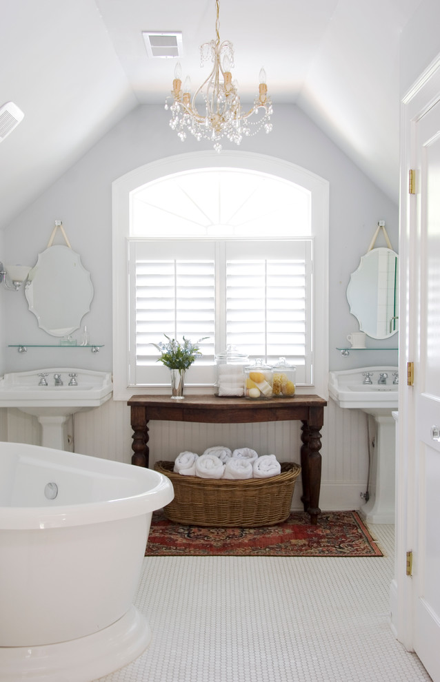Photo of a traditional bathroom in Atlanta with a freestanding tub and a pedestal sink.