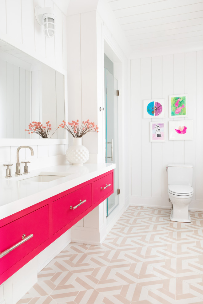 Photo of an expansive transitional kids bathroom in New York with an alcove shower, white walls, an integrated sink, marble benchtops, a hinged shower door, white benchtops, a double vanity, a built-in vanity, panelled walls, flat-panel cabinets, red cabinets, ceramic floors, multi-coloured floor and timber.